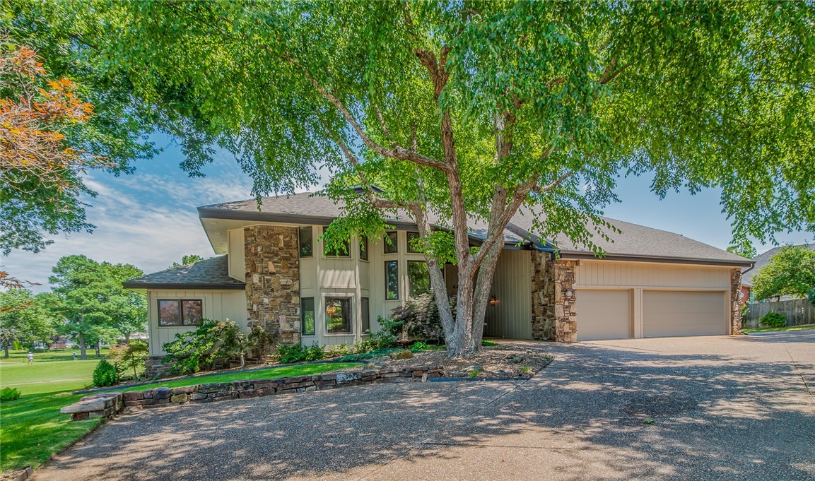 Located on the Springdale Country Club golf course, this 3,754 sq ft home overlooks the 7th and 8th holes from a beautifully landscaped 0.43-acre cul-de-sac lot with mature trees. Offering 3 bedrooms, 3 full baths, and 1 half bath, the floor plan includes a main-level office that could serve as a 4th bedroom. The open eat-in kitchen flows into the living room, where a wall of windows frames golf course views and a see-through wood-burning fireplace connects the living spaces. Enjoy the scenery from the screened porch and multiple decks overlooking the fairways. Additional features include a 3-car garage, attic lift, and new roof and gutters installed in 2025. Enjoy easy access to the public fishing pier and the Lake Fayetteville walking and biking trail network located just minutes away. Convenient to shopping, dining, schools, and I-49, this home offers an exceptional golf course location with nearby outdoor recreation.