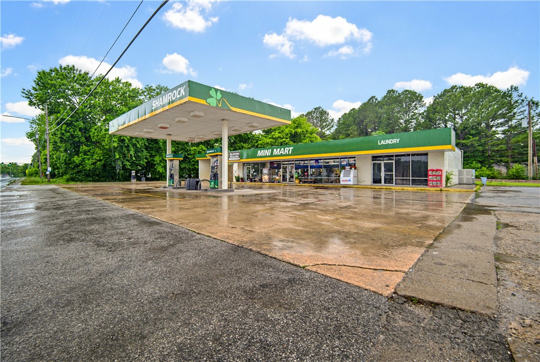 Exceptional commercial opportunity in a high-visibility, high-traffic location in the heart of Greenland! Positioned directly across from Greenland High School and just moments from Drake Field, this versatile income-producing property offers multiple revenue streams all in one investment. The property includes a convenience store, gas station, laundromat, car wash, and an additional lease space for even more income potential.  Located less than one mile from the White River and just minutes from I-49, this property offers excellent accessibility, strong local exposure, and consistent daily traffic from both residents and travelers alike. The laundromat and car wash provide great value-add potential with opportunities for updates and improvements to further increase income and overall property value. Surrounded by continued growth in Northwest Arkansas, this is a rare opportunity for an owner-operator or investor seeking an established commercial property with multiple income streams and strong upside potential.
