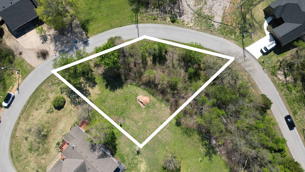 Live steps from trails, golf, and the lake! Nestled on a desirable corner lot on Eriboll Lane, this .28-acre property is a fantastic opportunity to build your dream home in Bella Vista. Located just minutes from the area’s premier golf courses, scenic Loch Lomond, and top-tier biking and hiking trails, this lot offers easy access to endless outdoor recreation. A completed perc test for a three-bedroom home means you’re all set to start designing your new residence. The neighborhood is growing, with several newly constructed homes reflecting the community’s increasing popularity. Exciting developments are also on the horizon, including the Walton family's Blue Crane project, which promises new dining, entertainment, and lifestyle amenities to enhance the Bella Vista experience. Combining natural beauty, modern conveniences, and a vibrant community, this lot is your gateway to the Arkansas lifestyle.