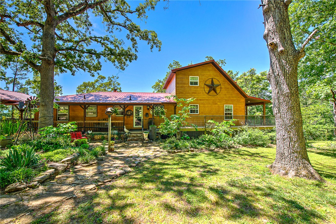 Tucked into the rolling hills of the Ozarks, with private riverfront access,  this property offers the kind of quiet country living that’s so desirable. Surrounded by natural beauty & just a short drive from the charm of Eureka Springs, this blends privacy, open space, & so many options. Included is barn with 2 horse stalls, manger and chicken coop. You’ll love the full garden, pumpkin patch & the apple, peach & plum trees too!
If you’re looking for a full-time residence, retreat, or investment opportunity, this delivers room to breathe, scenic surroundings, & endless potential. The cabin & the airstream provide more living space, perfect for guests or family members.
With its desirable rural setting, easy access to nearby rivers, trails, & recreation, & appeal of the Arkansas countryside, this property captures the spirit of Ozark living at its best. 
Original house was completely remodeled & sq ft doubled in size in 2017. New roof & new siding included! Property is being sold furnished. Also listed MLS#1347033
