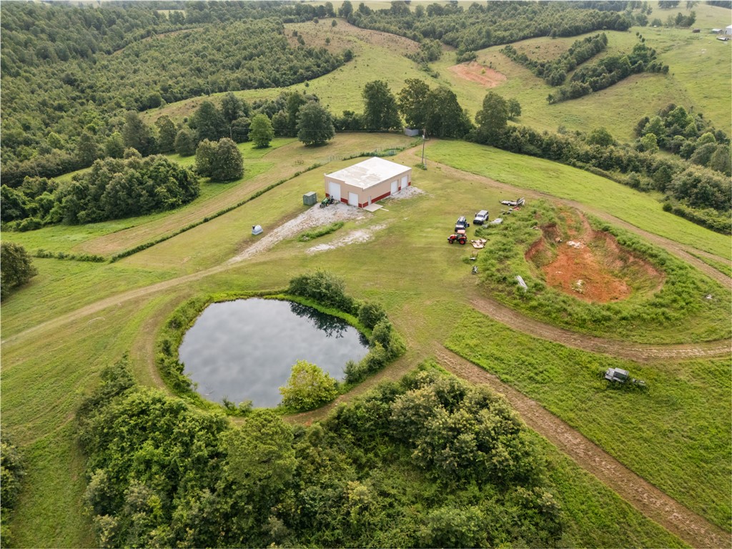 Located less than 3/4 miles off pavement, and only minutes from Highway 65 in Pindall, Ar. this Unique property eagerly awaits its new owner! The centerpiece of this 35 acre retreat rests on top of the highest hill. At over 2400+ sq ft this poured and reinforced concrete building was engineered to withstand the worst  conditions Mother Nature can produce! With 4 large doors to accommodate anything from an RV to a ATV, over 300 sq ft of finished living space with a full kitchen and bath, a spring fed, filtered, and pumped water system, full electric and propane heating the possibilities are endless. Use for a hub as you build, continue to develop the interior into more living space, or keep it as is! The location, amenities, and views are sure to impress!