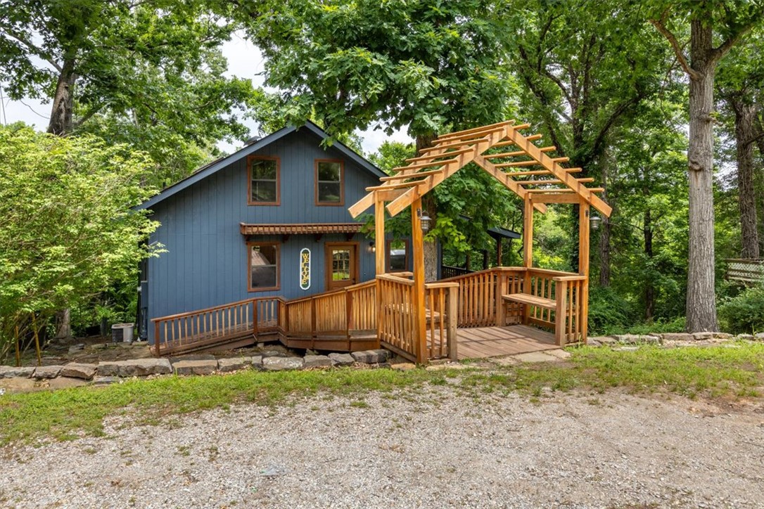 Tucked among the trees near Beaver Lake, this beautifully updated home features 3 bedrooms, 2.5 bathrooms, and a finished walkout basement designed for comfort and flexibility. Relax on the covered deck overlooking peaceful wooded scenery with a late seasonal view, while the charming loft offers the perfect space for a home office, reading nook, or additional guest accommodations. Modern updates throughout blend seamlessly with the home’s warm character and natural surroundings. Located just four blocks from the boat ramp, you’ll enjoy easy access to lake days, kayaking, fishing, and nearby hiking trails. Private, peaceful, and full of charm, this property, with common ground located behind it, is the ideal escape for full-time living or a weekend retreat.