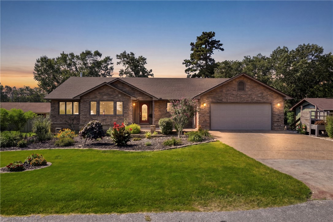 Beautiful Custom-built home in Holiday Island! Starting with the entrance, you are welcomed with well thought of flowers and foliage, along with tiered garden areas for vegetation growing. Brand new fencing, 2025, encloses the back yard for privacy and fun time! Four Bedrooms, on suite bath with jacuzzi tub, and custom-built walk-in shower. A full hearthstone fireplace surround replacement. Upgraded kitchen appliances. In 2024 Brand new Whirlpool Gas Range with Convection baking and air fryer. In 2025, Fire gas Hood including vented hood installed.  In 2022, 52" ceiling fans with lights installed. In 2023 brand-new, two-tier back deck.  Enjoy sunrise and sunset with panoramic views and surrounding nature! There is also a beautiful screened in sunroom, perfect for weather watching!  Located just minutes from the Country Club with full service restaurant.  Two golf courses, Recreation Center, community pool. Two lakes, about 4 rivers nearby. Grocery store nearby.  And not far from the Historic Eureka Springs!