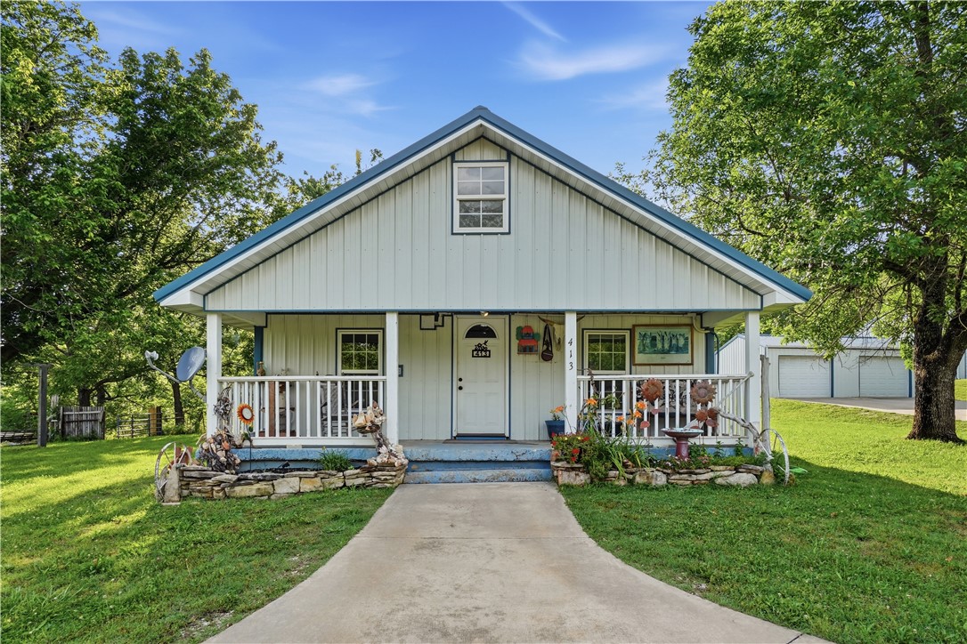 Positioned on 10.29 acres in a scenic Ozark Mountain setting near Kings River public access, this homestead offers an 1,296sq cottage featuring 2 bedrooms & 1 bath with updated wood flooring, an updated kitchen & comfortable single-level living surrounded by open acreage and mountain scenery. The gently rolling land provides ample space for gardening, hobby farming, recreation, or a future homesite.
A gated entrance welcomes you to a collection of outbuildings and workshop space. Improvements include a 40' x 20' detached garage with double doors, a 32' x 55' shop building with three 10' overhead doors and a 544sqft heated and cooled section, a 31' x 16' garage with two single doors, a garden shed, and a unique two-level 12' x 13' storage building featuring an upper storage area and lower-level pump house/root cellar. Whether for equipment, vehicles, workshops, storage, or future projects, this versatile acreage property offers endless possibilities in one of the area's most desirable recreational settings.