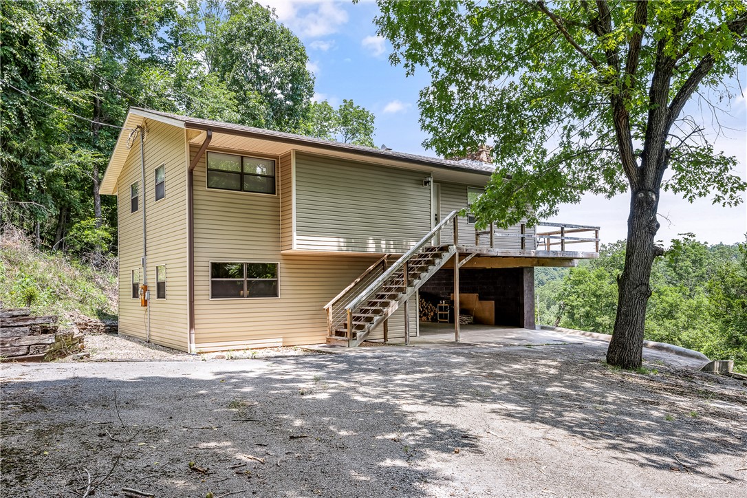 Welcome to lake living in the Beaver Lake area! This unique offering includes a charming  stilts built home, an additional parcel providing added privacy & future possibilities, plus a boat dock—an increasingly rare opportunity in NWA. Whether you're searching for a full-time residence, weekend retreat, or investment property, this package offers the lifestyle buyers dream about. Enjoy easy access to Beaver Lake's, boating, fishing, swimming, and year-round outdoor recreation. The additional parcel creates room to expand, build, or simply preserve the natural beauty surrounding the property. Nestled among mature trees in a peaceful setting, you'll appreciate the privacy and tranquility while remaining within convenient driving distance of Rogers, shopping, dining, and everyday amenities. Spend your days on the water, relax on the new elevated deck (2023) in the evenings, and make lasting memories at the lake. Plus updates include new heat pump in 2021; new siding in 2017; New retaining wall ,decl & flooring 2023.