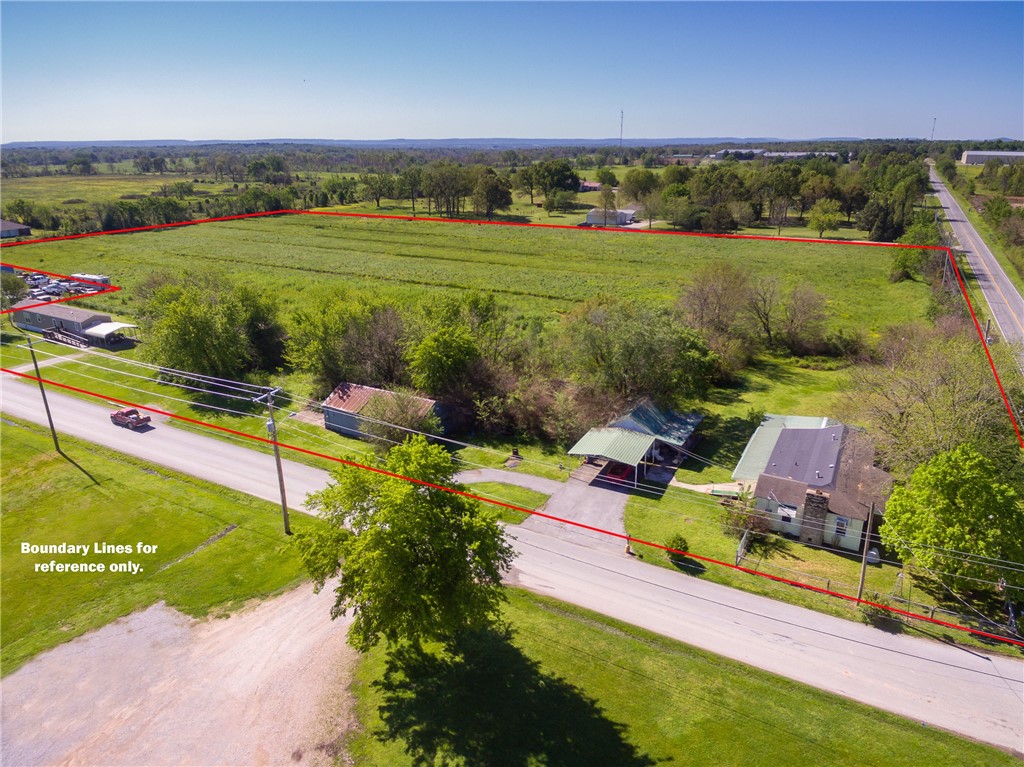 12.23 acres with frontage on Hwy 16.  Has potential for development or commercial.  Being sold as land only.  No value in the house and outbuildings.  Mobile home does not convey.  Occupant of the mobile has a life estate.  City limits line goes through the property.