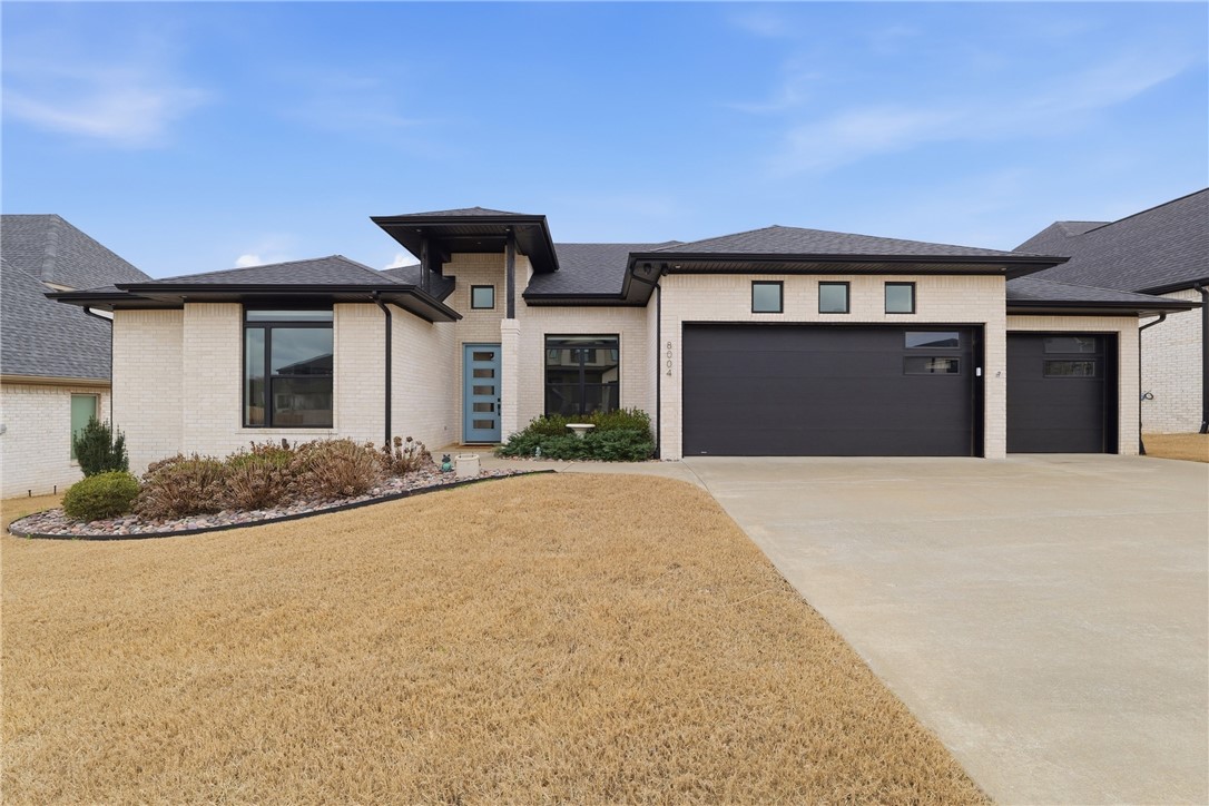 Beautiful 4-bedroom, 3-bath home with an expansive bonus room featuring a wet bar in the gated Shadow Valley community of Rogers, offering a thoughtfully designed open layout and hardwood floors throughout. The spacious living area with fireplace flows into the well-appointed kitchen offering quartz countertops, pantry, and a double oven—perfect for both everyday living and entertaining. The private primary suite provides a relaxing retreat with a well-designed bath and walk-in closet. Additional features include light dimmers, wired-for-sound capability, and a 3-car garage. Enjoy outdoor living from the screened-in back porch overlooking the backyard, complete with an outdoor fireplace, extra concrete pad ideal for a grill area, and French drains along the back of the home. Located in Shadow Valley with gated access and community amenities including a clubhouse, pool, tennis courts, fitness center, and convenient access to I-49, shopping, and dining.