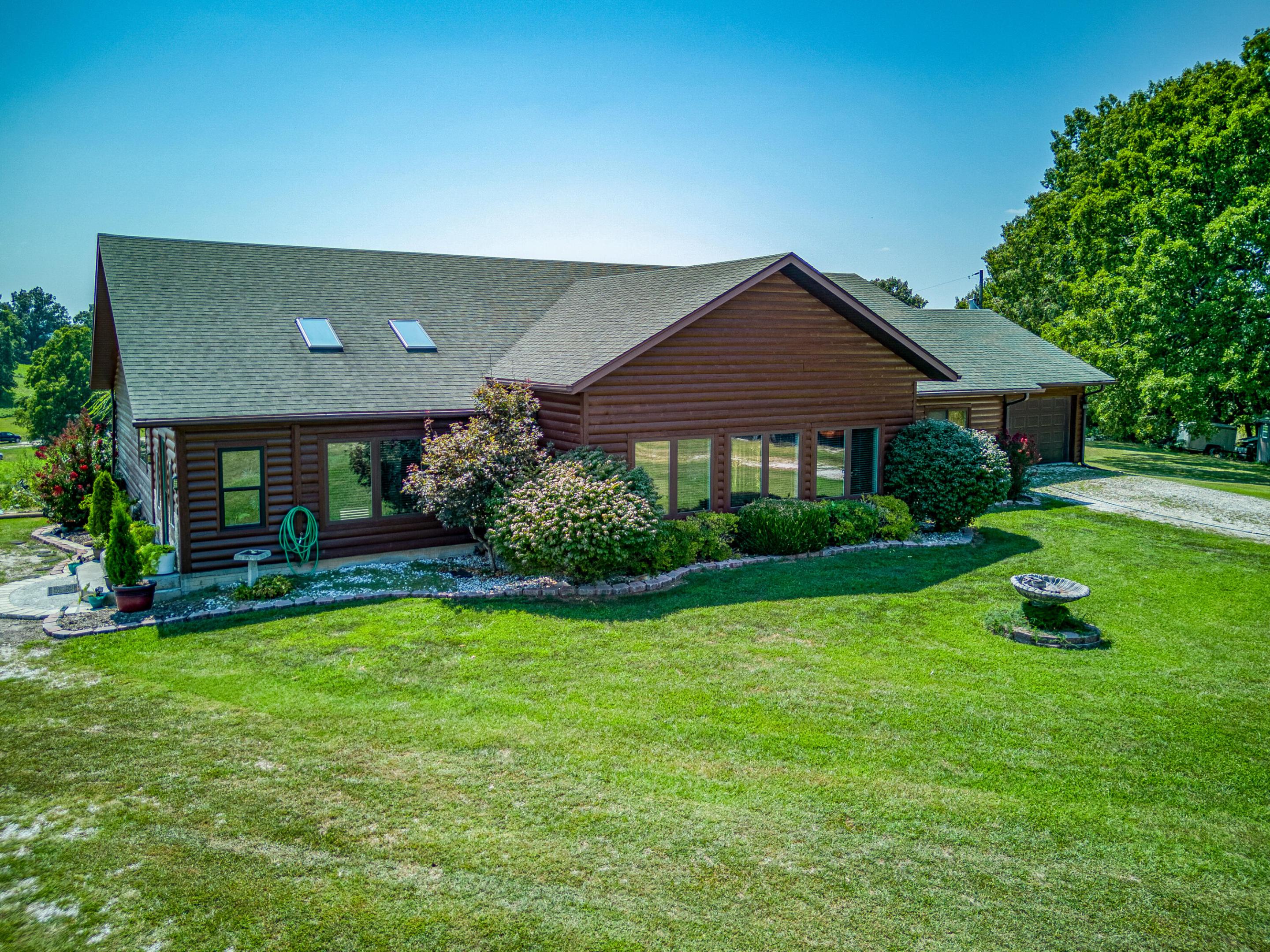Stunning, Simply Stunning! Looking for a home on 10 acres that is peaceful, with an amazing view and an open floor plan.....and is close to town? Check out this 3 BR/ 21/2 BA with large back deck overlooking a beautiful view. Vaulted ceilings, floor to ceiling windows lets in the natural light. Above ground pool remains at the home.  From the sunroom to the large bedrooms and open concept, this home has it all.  Even has a storm shelter! 2 car garage, LARGE primary bedroom opens to the sunroom to enjoy that morning cup of coffee while you take in that peaceful view.  Kitchen has a unique granite island unlike any other! Come see this home today! You will not be disappointed!
