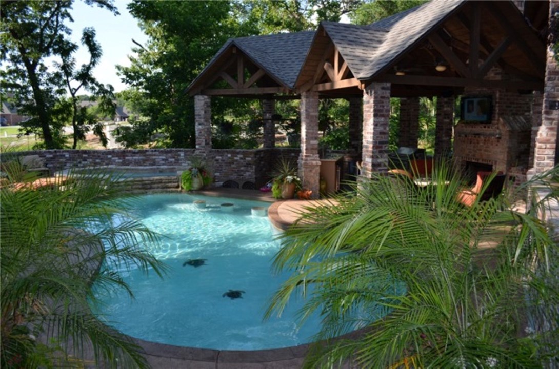 Make this resort style paradise your home! Quality Mark Melton Construction in desirable gated Pinnacle CC. Massive gourmet kitchen, wine room open to LR w/views of the unbelievable pool and attached hot tub, swim up bar, multi-leveled covered patio, built-in grill/mini-fridge/fireplace, and abundant privacy! Master suite with huge closets. Circular staircase to mid-level study, 3 bedrooms up, exercise room and media/game room with kitchenette. Great curb appeal with the side load 4 car garage.