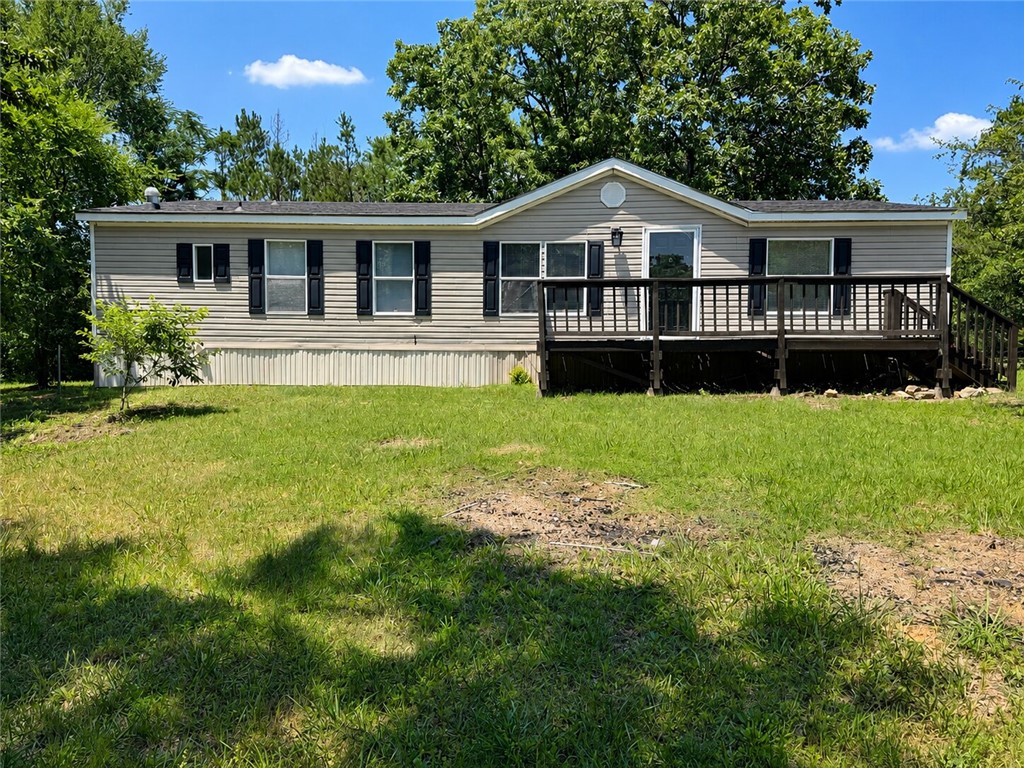 Fully remodeled country retreat on 5 beautiful acres backing up to the National Forest! This spacious 1664 sq ft home offers privacy, in a peaceful setting just minutes from Two Rivers School. Inside features a cozy wood-burning fireplace, two living areas, dining room, and a bright kitchen with abundant cabinetry and updated appliances. Split floor plan with oversized guest rooms, plus a private master suite boasting a huge walk-in closet, double vanities, jetted garden tub, and walk-in shower. New roof, new HVAC, and detached storage building complete the package.