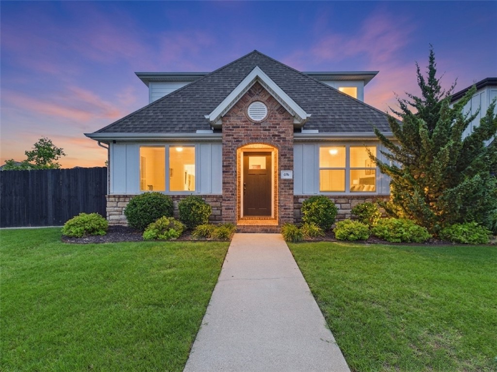 SIX minutes to the U of A campus, this 4-bedroom, 3.5-bath corner lot home in Forest Hills checks every box. The main level features wood-look tile throughout, an open floor plan, and a spacious living room with gas log fireplace and brick veneer surround. The kitchen shines with quartz countertops, brick veneer backsplash, freshly painted cabinets, farmhouse sink, kitchen island, electric range, dishwasher, and new microwave. A dining area with a patio door opens to a private, fenced patio. The main-level primary suite includes a walk-in closet, tiled shower, and dual vanities. A spacious laundry room and half bath round out the main floor. Upstairs are three bedrooms including one with a private bath and two sharing a jack-and-jill. Forest Hills amenities include lawn care, snow removal, and a community pool. Freshly painted and move-in ready! 11 mins to Downtown Fayetteville/Dickson Street, 12 minutes to Washington Regional Hospital and 22 mins to XNA.