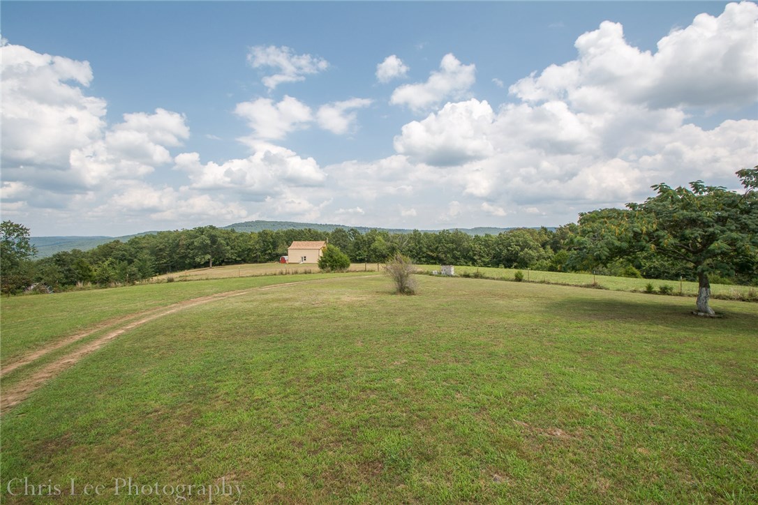 Hill top 149 acres w/awesome views! Great building site to take in those views.  Property was being developed into a vineyard. Cool well built 2 level barn/shop w/power was to be the winery.  Approx 15 acres of pasture (some additional land had been partially cleared).  Natural flowing spring had provided water for two houses. Great spot to call home, use as recreational get-away or vineyard! Wildlife abounds! Electric & existing septic on site. 6/10th mile off pavement. 20 minutes to Harps In Elkins.