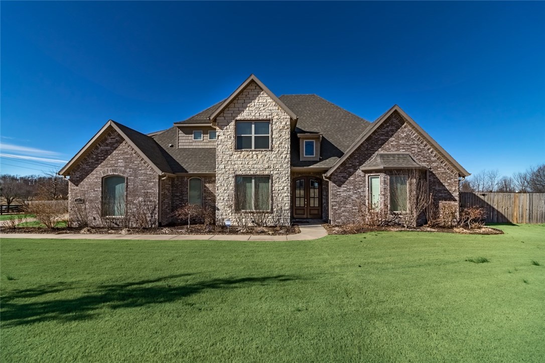 Accented by the vaulted & beamed ceiling w/ stone fireplace in the living RM, this brick & stone home has been fully & lovingly landscaped. Enjoy the views from the screened back porch w/ brick fireplace that overlooks the 1.6+ acre yard. Spacious kitchen w/ abundant granite counter space, SS appliances, including dbl ovens, adjacent laundry & breakfast areas, formal DR, study & master suite all on first level. 3 oversized BRs, large bonus w/ wet bar, a 2nd laundry RM & 2 full BA round out the upstairs.