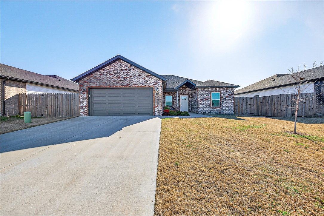 This like-new, beautifully maintained home offers the perfect blend of modern comfort and prime location. The property features a bright & inviting open-concept layout with a spacious kitchen and living area, making it ideal for both relaxed everyday living & effortless entertaining. A thoughtfully designed split floor plan ensures maximum privacy for the primary suite, while the additional bedrooms provide versatile space for family, guests, or a dedicated home office. The stylish kitchen features premium finishes & ample counter space, flowing seamlessly into the main living areas. Outside, the backyard comes complete with raised garden beds, offering a peaceful retreat for gardening or outdoor relaxation. This home sits just minutes from Downtown Bentonville,the Walmart Home Office campus, Crystal Bridges Museum, Coler Mountain Bike Preserve, and Slaughter Pen Trails, putting the very best of shopping, dining, and entertainment right at your doorstep.  Fridge, washer and dryer included.