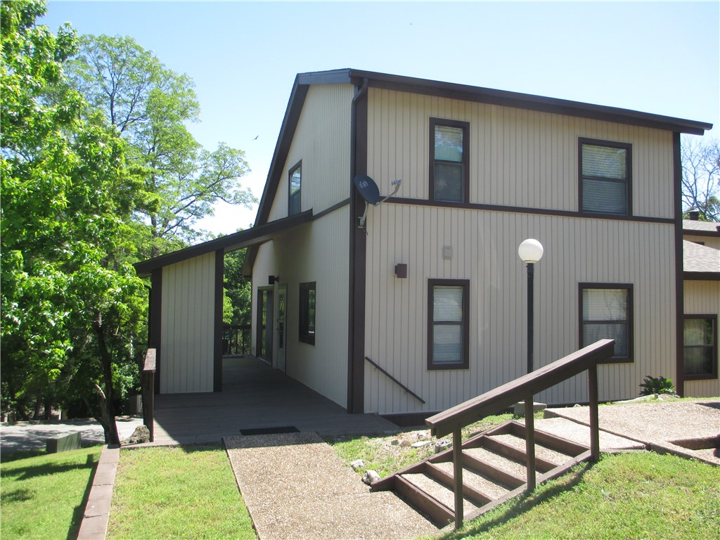 This condo is conveniently  located so you can Enjoy the Lake Life!  Close proximately to Table Rock Lake, the marina, 9 hole golf course, the recreation center, two swimming pools & so much more!! Make this your  permanent home or weekend getaway.  Investment possibilities if you choose to use it as a nightly rental.   Lovely 2 bedroom 2 bath has been freshly painted, newer carpet & flooring  is move in ready. Big deck for dining al fresco includes 2 storage rooms for all your toys. The open concept of the living and dining space is graced with a woodburning stove & cathedral ceiling. Covered parking for 1 vehicle, an additional space & another storage room.  Situated on a big corner lot provides green space for yard games, best part...you don't have to take care of the grass.