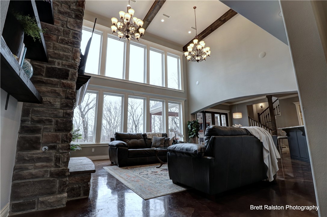 Beautiful custom home on 4.23 acre estate in highly sought out Versailles!  Built in 2015, this 2 level English Country style home brings it all!  From the curb the stately homes stately sets deep into the lot.  A curving sidewalk from drive and a large porch wrapping around the front welcome you home.  At entry, captivating 20' tall wall of windows overlooking the back acreage. Natural light filled home office and formal dining room flank the front. Private and serene owners suite has well appointed closet/storage space and spa bath. Kitchen is decked out with all the features for the cook and chef of all levels.  Upstairs-Theatre room and work out room share a conveniently located 1/2 bath, Two bedrooms with on-suite baths and 2 Jack and Jill bed/bath. The stunning brick fireplace soars above the balcony to the ceiling.  Wonderful covered patio w/ fireplace, open deck w/hot tub. Wired for whole house generator, plumbed for whole house vacuum.  Roof solar panels, remote control lawn mower, radiant decking convey!