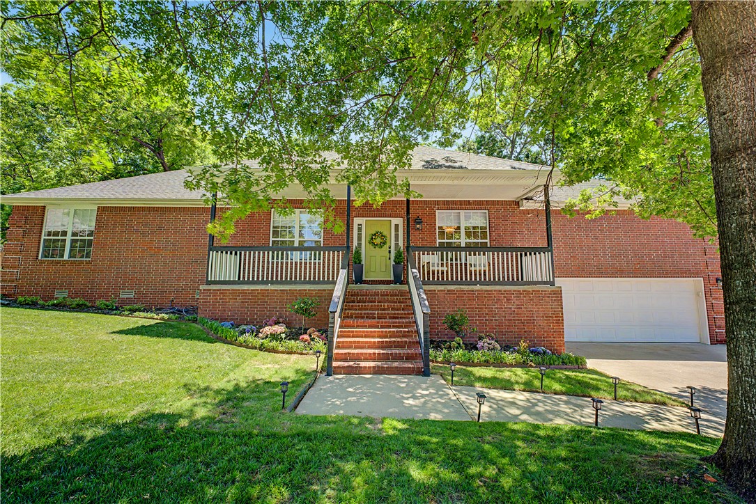 Everything you are looking for. Spectacular 4 bdrm home sits at end of cul-de-sac with easy access to I-49, hospital, shopping, direct access to Razorback Greenway, private bedroom with en suite bath or great office/exercise room.  Create your own personal oasis on a 45x15 deck with pergola overlooking a parklike backyard with mature trees and view of golf course and lake. Freshly painted walls and cabinets throughout. Whole house hot water heater and recirculation pump 2023, new ceiling fans 2026, carpet and laminate flooring 2022, custom fitted shades 2023 and 2026, new counter tops in kitchen, and hot tub hookup. The garage has a large storage area.