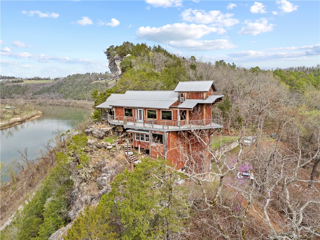Perched on a bluff overlooking the White River, this one-of-a-kind property is built for both experience and income. Constructed from repurposed shipping containers, it delivers a design that stands out—from recycled spiral staircases to its bold industrial-meets-nature aesthetic.

The views are the draw. The uniqueness is the hook. This is the kind of property that gets saved, shared, and booked.

Inside offers flexible living space, including a top-floor “penthouse” bedroom that elevates the experience and rental appeal. Ideal for a high-performing Airbnb, weekend retreat, or full-time residence.

Situated on 2 acres with room to expand—add additional units or create a multi-structure rental setup.

If you’re looking for a property that performs and stands out, this is it.