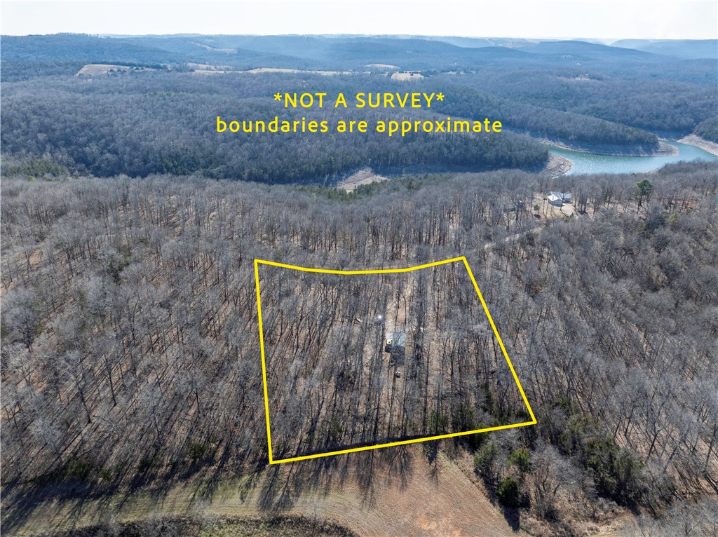 Discover 3.23 wooded acres in the sought-after Webb’s Landing 3 Subdivision near Bull Shoals Lake, offering a peaceful Ozark setting with potential lake views and excellent recreational access. This property includes a Derksen shed hunting cabin, complete with heating & cooling and a propane stovetop, making it a great base camp for weekends or hunting season. No water or septic currently in place.
Enjoy quick access to Bull Shoals Lake for fishing, boating, and recreation, along with a nearby public boat launch. Aviation enthusiasts will appreciate proximity to Pine Mountain Air Park (6AR9), the private fly-in runway located within the development. With light restrictions to help protect the area while still allowing flexibility, this lot is ideal for building your dream home, lake retreat, or future cabin. Conveniently located in the Ozarks and approximately one hour from Branson, Missouri, this is a rare opportunity to own acreage with lake access and aviation amenities nearby.