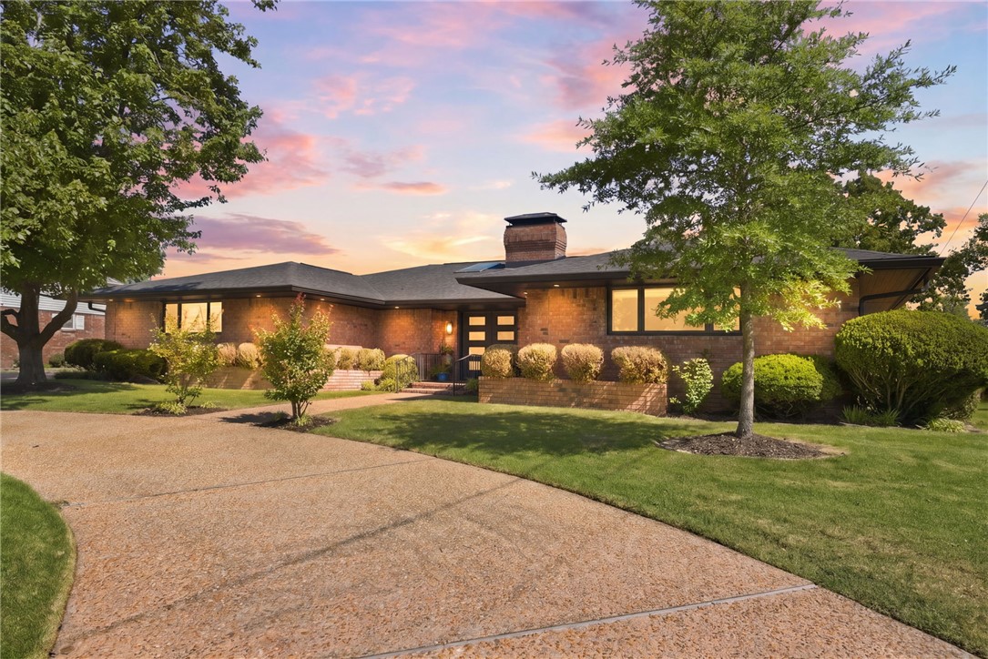 Completely renovated mid-century modern home right on the Springdale Country Club golf course. Perfectly positioned near the country club and just 2 minutes from Lake Fayetteville, this home feels like a quiet retreat while still being close to everything — shopping, dining, trail access, etc. Inside, every inch has been thoughtfully updated while maintaining the home’s original character and charm. New engineered white oak flooring and stunning Italian tile run throughout most of the home. The oversized kitchen has new custom white oak cabinetry, quartz countertops, top-of-the-line appliances, a large pantry, and more. Expansive windows, golf course views, and natural light throughout create an effortless indoor-outdoor feel. A sunroom overlooking the course, beautifully landscaped yard, and oversized patio create the perfect setting for morning coffee, entertaining, or winding down at the end of the day. Stylish, sophisticated, and completely move-in ready — this is one you truly have to see in person.