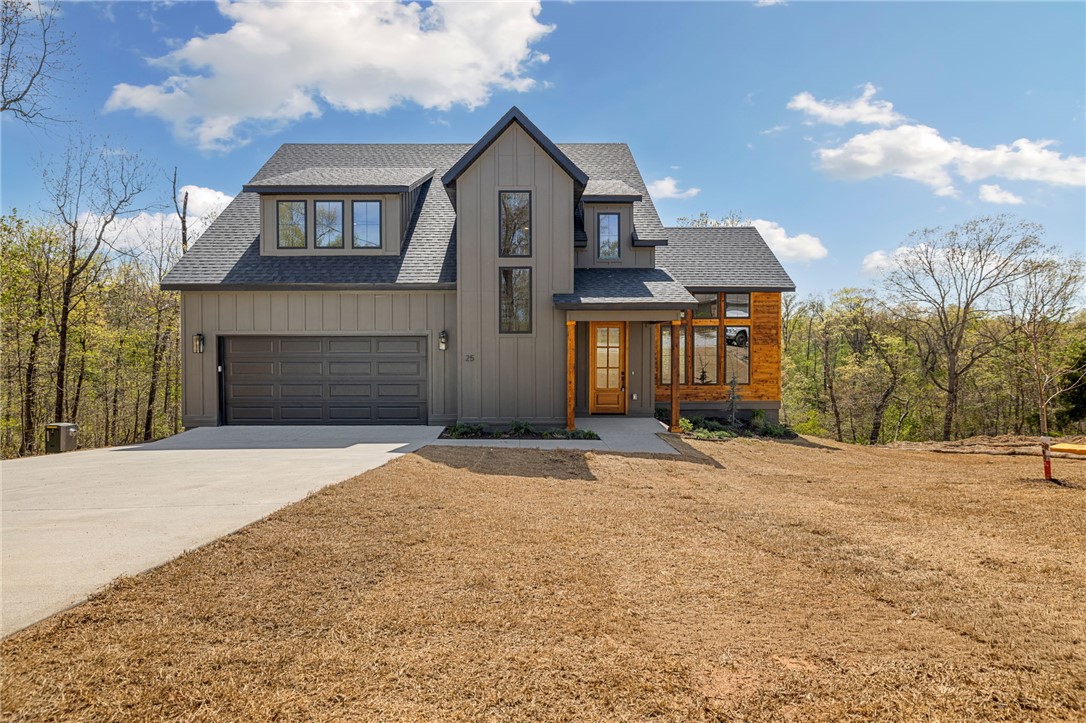 Stunning new construction near Lake Lomond in Bella Vista! This 3 bed, 2.5 bath home blends modern design with warm, natural finishes and thoughtful upgrades throughout. Hardwood floors flow seamlessly across the main and upper levels, creating a cohesive, high-end feel. The chef's kitchen is a true showstopper, featuring quartz waterfall island, custom cabinetry, designer lighting, subway tile backsplash, gas range, and abundant storage-perfect for entertaining or everyday living. The private primary suite offers a spa-like bath with dual vanities, soaking tub, tiled walk-in shower, and elegant gold fixtures. Enjoy the convenience of a laundry area in the primary closet plus a full upstairs laundry room. Upstairs you'll also find a versatile loft and dedicated office space. Relax on the covered deck overlooking serene, wooded surroundings just minutes from Lake Lomond.