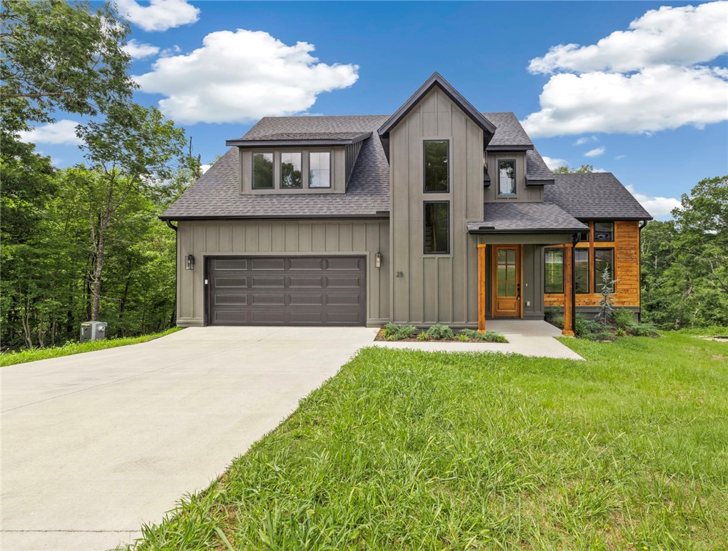 Stunning new construction near Lake Lomond in Bella Vista! This 3 bed, 2.5 bath home blends modern design with warm, natural finishes and thoughtful upgrades throughout. Hardwood floors flow seamlessly across the main and upper levels, creating a cohesive, high-end feel. The chef's kitchen is a true showstopper, featuring quartz waterfall island, custom cabinetry, designer lighting, subway tile backsplash, gas range, and abundant storage-perfect for entertaining or everyday living. The private primary suite offers a spa-like bath with dual vanities, soaking tub, tiled walk-in shower, and elegant gold fixtures. Enjoy the convenience of a laundry area in the primary closet plus a full upstairs laundry room. Upstairs you'll also find a versatile loft and dedicated office space. Relax on the covered deck overlooking serene, wooded surroundings just minutes from Lake Lomond.