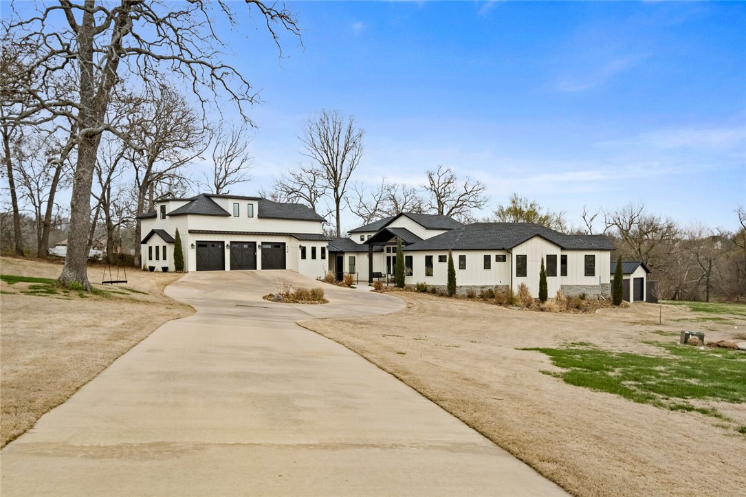 EXPERIENCE LUXURY LIVING IN CUSTOM BUILT 2019 HOME ON 2.38 ACRE ESTSTE LOT WITH CREEK. Enjoy 5 bedrooms, each with en suite bathrooms and walk-in closets, plus a studio guest house with bedroom, full bath, kitchenette and private entrance . The 20-ft tall ceiling and windows fill the house with natural light. A fireplace, gourmet kitchen with a massive island, top-of-the-line appliances, butlers pantry, 2 built-in homework/office areas and 3 season sun room cater to all your needs. The backyard oasis features a heated saltwater pool, hot tub, out door shower, in-ground fire pit, basketball pad, outdoor fireplace/bar area perfect for hosting! Includes 3-car and John Deere garages, workshop space, mudroom, dog feeding station and secret room. Bentonville school district, minutes from downtown, Coler bike trail, and the 100-acre park being built by the Walton Foundation. Don't miss this extraordinary contemporary farmhouse estate home!