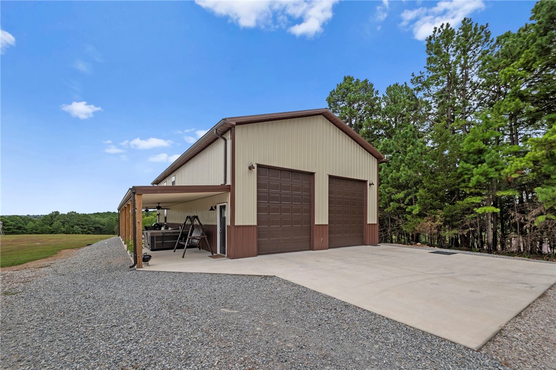 Looking for peace, privacy, and room to roam? This custom-built barndominium sits on 9± acres and was constructed like a traditional home with 2x6 walls, spray foam insulation, LED lighting throughout, a private well with filtration system, whole-house generator, and underground utilities. Offering 2 bedrooms, 2 baths, and 2 living areas, the second living space could easily serve as a third bedroom. All bedrooms feature walk-in closets, including a spacious primary suite. The kitchen and baths showcase custom cabinetry and granite countertops. The attached 30x40 garage includes two 10x12 overhead doors, providing ample space for vehicles, an RV, boat, or recreational equipment. Enjoy the covered 10x60 porch while watching wildlife and taking in the peaceful surroundings. A 40x70 limestone pad with utilities and two RV hookups is ready for future expansion. Located just 3 minutes from Big Clifty Park on Beaver Lake, 15 minutes to Eureka Springs, and 45 minutes to Springdale. Up to 35 acres available.