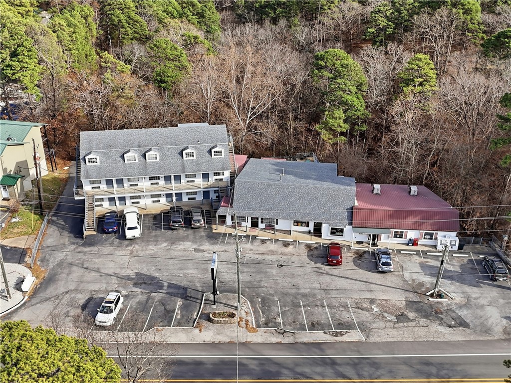 Introducing Alpine Liquor & Lodge, a rare opportunity to acquire two established, highly profitable businesses in the thriving tourist destination of Eureka Springs. Located on +/- 2.8 acres right on Hwy 62/E Van Buren with approx. 7,000 VPD, this high-visibility property offers excellent access and exposure. The income-producing property includes a successful liquor store—one of only three in town—and a well-maintained 22-room lodge, both with strong operating history. The store features large walk-in coolers, 3 new mini splits, and a generator system. The lodge offers 9 long-term rental units and 12 nightly rentals, creating stable, diversified revenue. A spacious lobby and +/- 1,472 SF top-level manager’s quarters. The sale includes furniture, fixtures, and equipment, inventory available separately. Also included are 32 parking spaces and +/- 1.13 acres of unused land. With no new liquor licenses available in Carroll County, this is a strategic investment opportunity in one of Arkansas’s premier tourism markets.