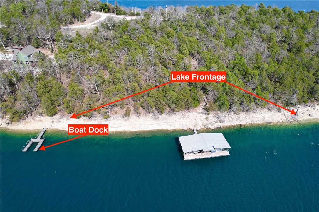 Spectacular 13.07 Acre Lakefront Property on Beaver Lake! Don’t miss this rare opportunity to own a stunning piece of paradise in Northwest Arkansas. Located at the end of Slate Gap Road in Garfield, this expansive property offers approximately 1,000 feet of pristine lake frontage on both sides of the property, providing panoramic views and serene privacy. The land features multiple potential building sites—ideal for your dream home, a family retreat, or an investment property. A boat dock with a current permit is included, allowing immediate access to one of Arkansas’s most coveted lakes. Tucked behind a locked gate shared with only two other property owners, this secluded setting offers peace, security, and exclusive access. Whether you’re looking to build now or hold as a future investment, this property delivers unmatched value and potential.