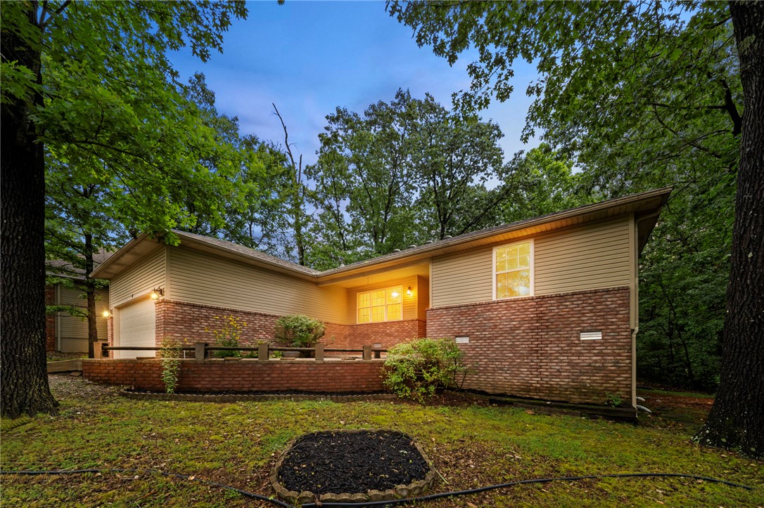 This move-in ready 3 bed, 2 bath home includes a BRAND NEW roof, BRAND NEW luxury vinyl plank in the living areas, and carpet in the bedrooms, and BRAND NEW connection to Bella Vista city sewer—a major improvement required by the POA upon transfer and already completed by the seller. This split-bedroom floor plan features a spacious living area with a cozy corner fireplace, a formal dining room, and a charming bayed breakfast nook overlooking the trees. The primary suite checks every box with double vanities, a whirlpool tub, walk-in shower, and a generous walk-in closet. Additional highlights include abundant storage throughout the home, garage, and lower-level storage areas, a large lot, spacious patio, and a quiet street ending in a cul-de-sac. Conveniently situated near Bella Vista amenities, trails, golf, and recreation, this home offers the perfect combination of tranquility and accessibility.