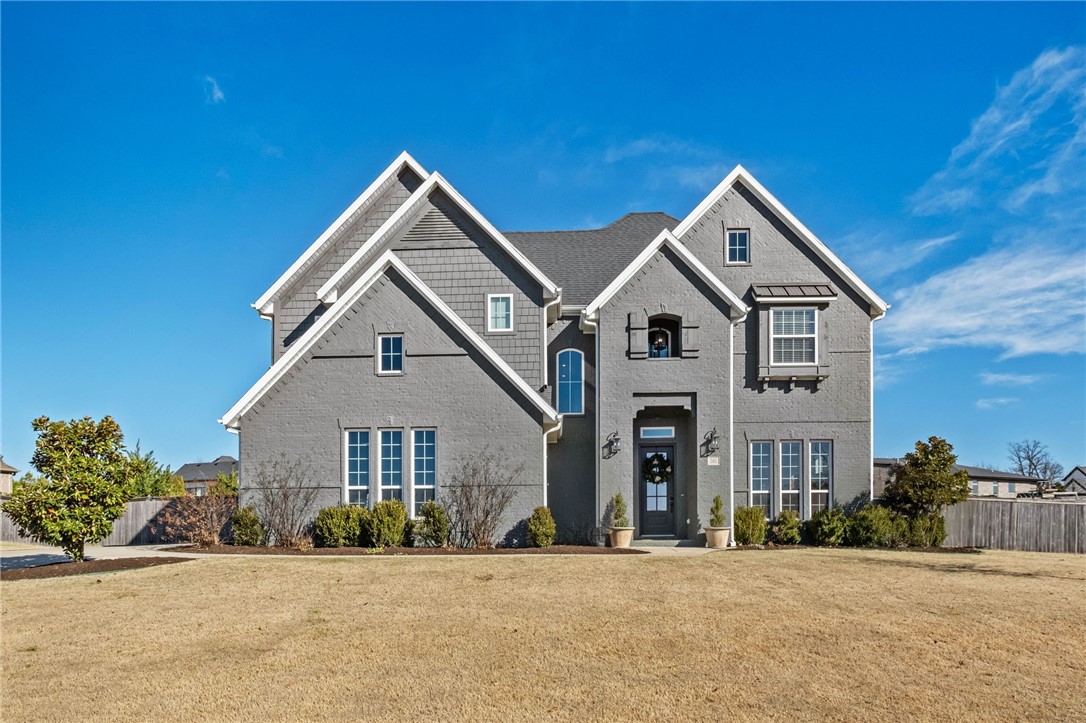 Welcome to this striking designer home in the Otter Creek community of Cave Springs, where bold style meets everyday comfort. The impressive exterior sets the tone for a thoughtfully curated interior featuring soaring ceilings, wide-plank hardwood floors, and dramatic architectural details throughout. The open-concept living area flows seamlessly into a show-stopping kitchen with rich cabinetry, statement lighting, and an oversized island ideal for entertaining. Retreat to a luxurious primary suite with spa-like ambiance, custom finishes, and generous natural light. Step outside to a private backyard complete with a custom built outdoor kitchen—perfect for hosting and enjoying Northwest Arkansas evenings. Each space is intentionally designed with elevated colors, textures, and modern flair. Enjoy access to Otter Creek’s premier amenities, including a community pool, pavilion, fishing pond, and pickleball court. Centrally located near Bentonville, Rogers, top dining, shopping, and trails.