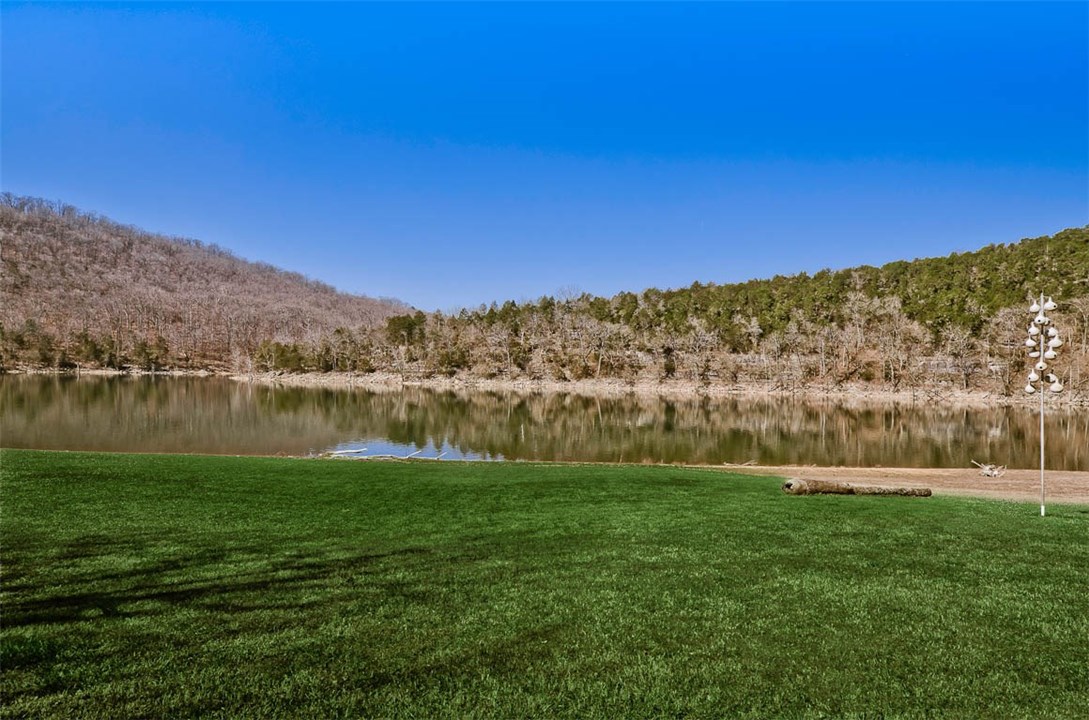 This is lake front living at it's best! Super gentle walk to waters edge. Launch your boat from your own backyard. This spacious home features two large living areas, game room, wet bar, screened rooms, large decks and extra storage. The home is just a short drive from all Holiday Island amenities, golf, tennis, swimming, hiking trails and shopping. The current owner has done a ton of remodeling and updating since purchase, improving the home's function. This is truly a must see to appreciate property!