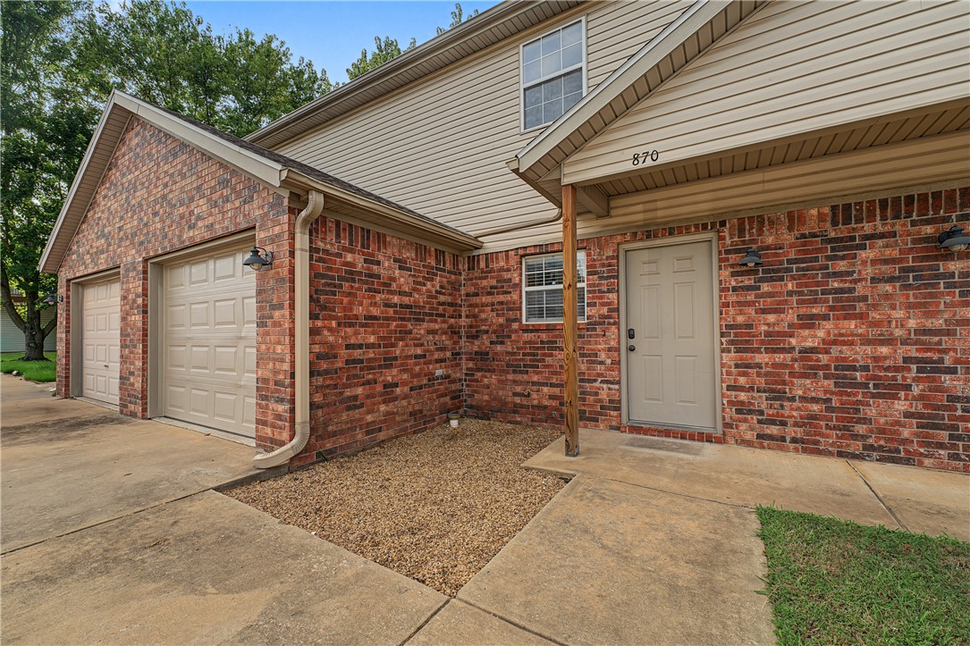 Tucked into the desirable Georgian Place subdivision, this charming 2-bedroom, 2.5-bath brick townhouse offers approximately 1,496 square feet of comfortable, upgraded living just one mile from the University of Arkansas campus, making it an ideal spot for students, faculty, or investors alike. Recent updates include refreshed granite countertops, updated flooring, new paint, and modern light fixtures, so the home is truly move-in ready. Inside, you'll find a cozy gas-log fireplace in the living room, an eat-in kitchen, walk-in closets, and stylish finishes throughout, while the fenced backyard and private patio create a relaxing outdoor retreat. With an attached garage, convenient access to the U of A bus route, and just a short stroll to the Razorback Greenway, this home blends everyday convenience with an unbeatable location near shopping, schools, and hospitals.