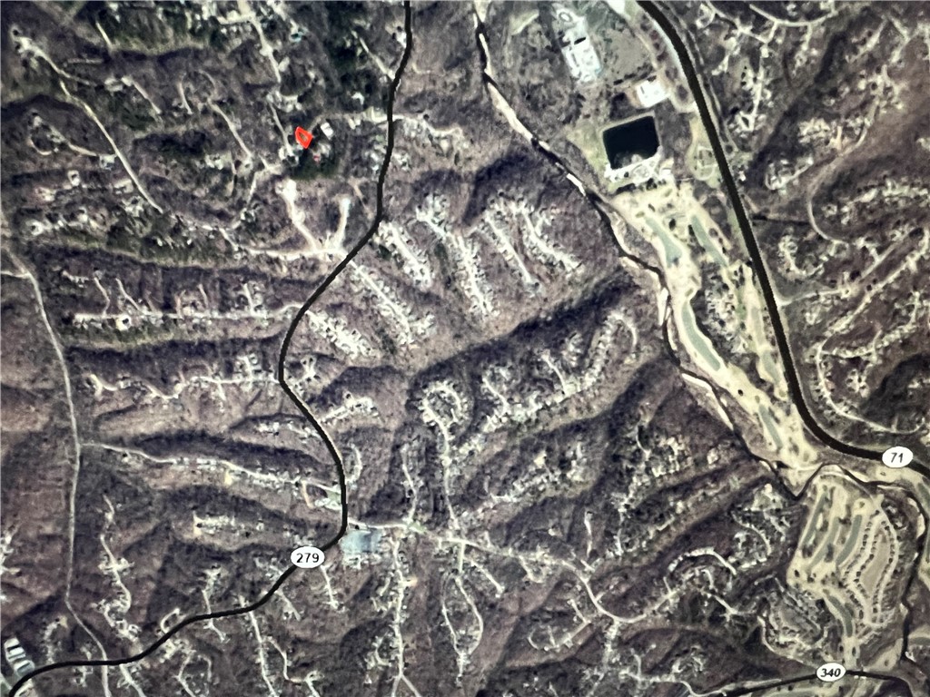 Trail-Rich Lot at the Northern tip of Bella Vista Golf and Country Club! Tunnel Vision and Golf Course ~1/3 of a mile, Technical Difficulty, Staggerwing, Long Shadow, and Bamboozled all within 1 mile from the lot. Nestled among rolling hills, crystal-clear lakes, and mature trees, this property is ready for your dream home or investment build. Whether you’re looking for a quiet retreat, a vacation getaway, or your dream home in the Ozark Mountains with Big-City Access less than 10 miles away, this is your lot.  Benton County is the Mountain Bike Capital of the World and all of NWA is connected by Trail, offering Concerts, Festivals, Dining, Shopping and much more!  Come join the party and relax with us in the Recreation/Resort City of Bella Vista!