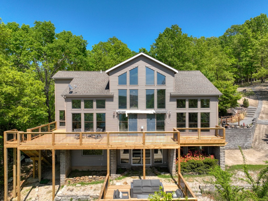 Take a look at this private, 6 acre Beaver Lake front property! Hike on your own ground and walk down to the clear water of Beaver Lake! This beautiful 4 bed/4 bath, 3244 square foot main home sits next to the cozy 1 bed/1 bath, 672 square foot guest quarters located below the detached garage. Both buildings have a view of the water and are secluded, but easy to get to on paved roads! Relax and enjoy the lake view from any of the three recently rebuilt decks. The open floor plan feels great with large windows everywhere you look! The master bedroom is on the main floor, along with a large loft above, and a large lower level with two additional bedrooms. This house is located very close to Starkey Marina and the amenities and fun of Eureka Springs are only a short drive away!