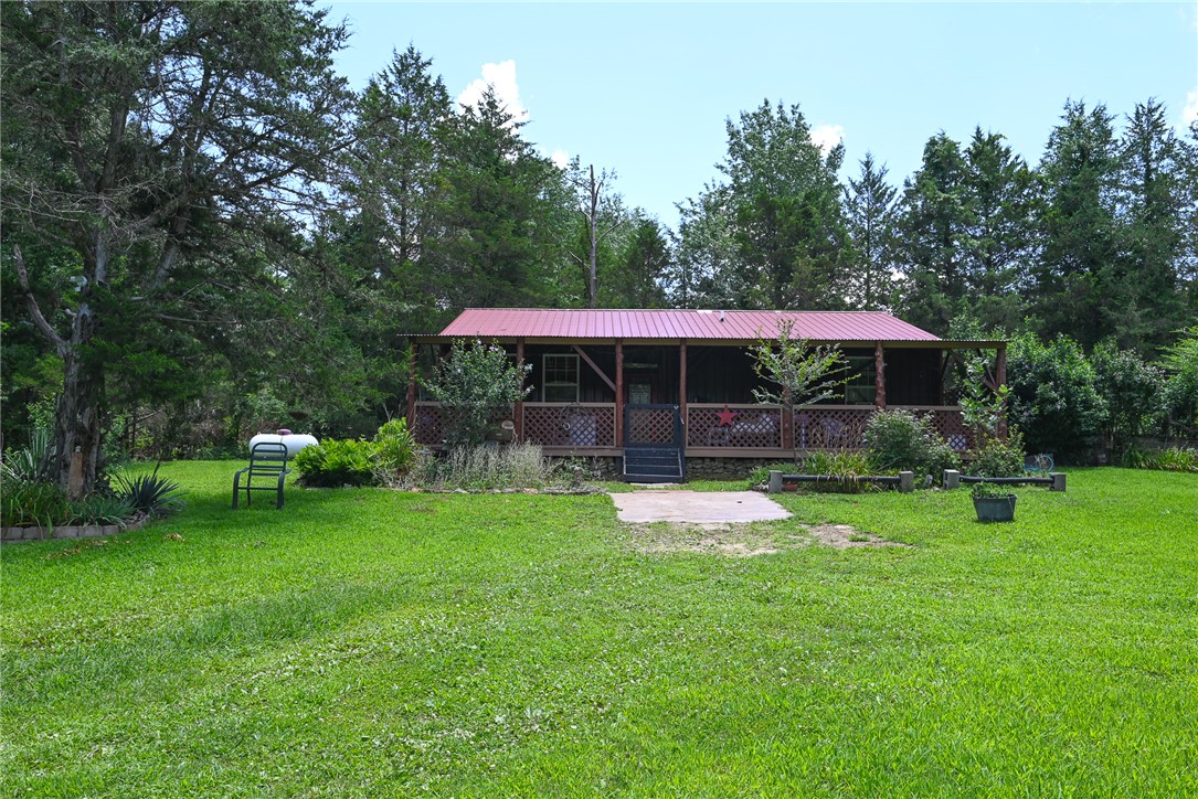 Rare opportunity south of Harrison!  Pristine, 11-year-old home on 3.26 partly-wooded acres in a coveted south Boone County location just a stone's throw from Highway 7.  Full-length covered front porch spans entire 40-foot face of the metal home. Inside the immaculate 1,200 sq ft (40x30) main home, you'll find warm, premium finishes, including durable concrete floors, metal ceilings, and beautiful 6" pine tongue-and-groove walls that give it a hospitable, high-end cabin feel.  In addition to the two bedrooms, check out the old fashioned claw foot tub in one of the two full baths!  Beyond the main home is a wonderful standalone guesthouse beautifully finished with cedar interior walls—perfect for family, a mother-in-law suite, or an Airbnb. Positioned just a short drive from the Buffalo River, this property is an incredible find for anyone wanting a small hobby farm, a serene homestead, or a lucrative vacation rental. 
Washer, dryer, refrigerator and microwave do NOT convey.