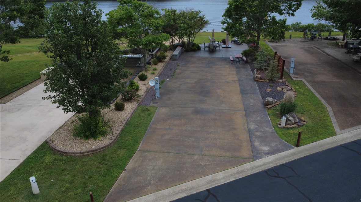 Take your adventurous side outdoors to play at the Ozark Outdoor Resort at Table Rock Lake. RV Lot #126 offers front and center water front views and unforgettable sunsets. Wide Lot features plenty of parking along side your motor coach or bus, outdoor lighting, the rustic finds in both character and lush landscaping will appeal to the finest of tastes and the conveyance of furniture will include everything you see in the photos for immediate relaxation upon arrival. Join the fun at the activity center, Cruise the water side with a golf cart rentals and settle into the cool night with a hot tub soaking at the owners clubhouse.   The resort provides a 12-slip courtesy dock for owners and guests with a boat launch ramp for easy lake access. Left something behind? you're going to love the close proximity to a nearby full-service marina at Cricket Creek. 30 minutes to Branson