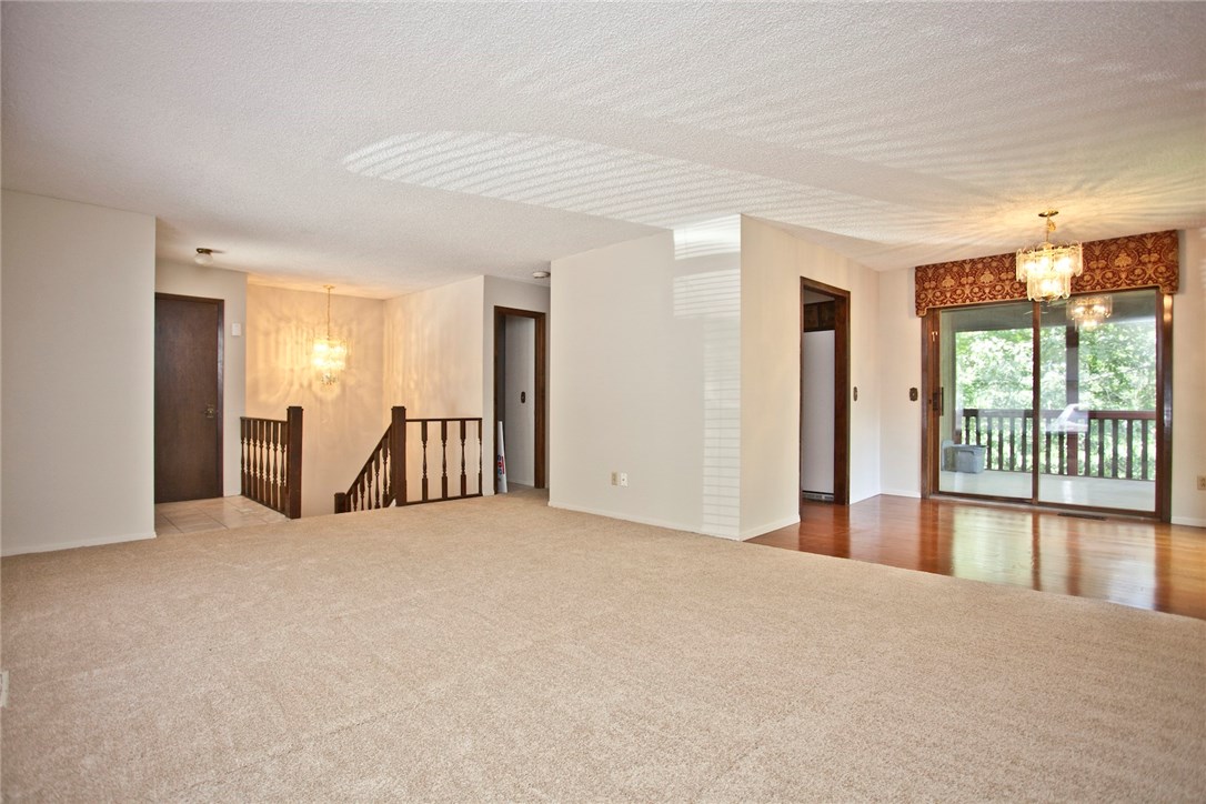 "BRAND NEW CARPET & FRESH PAINT" throughout this wonderful home.  This quaint home offers so much at such an affordable price.  You will love the two living areas upstairs & the shaded screened in patio.  In addition to the two large bedrooms this home offers a large bonus area perfect for a play room, craft room or additional storage & perfectly placed for a storm room.   The owners have taken very good care of this home & it's ready for your personal touch.  2 minute walk to Country Club golf coarse.