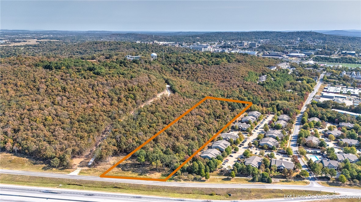 9.02 Acres Just 5 Blocks to the University of Arkansas Campus.  This land is currently zoned The New Neighborhood Services General Zoning. The land is wooded and has multi family apartments adjoining to the south and future project Student housing project that is being proposed adjoining to the North.