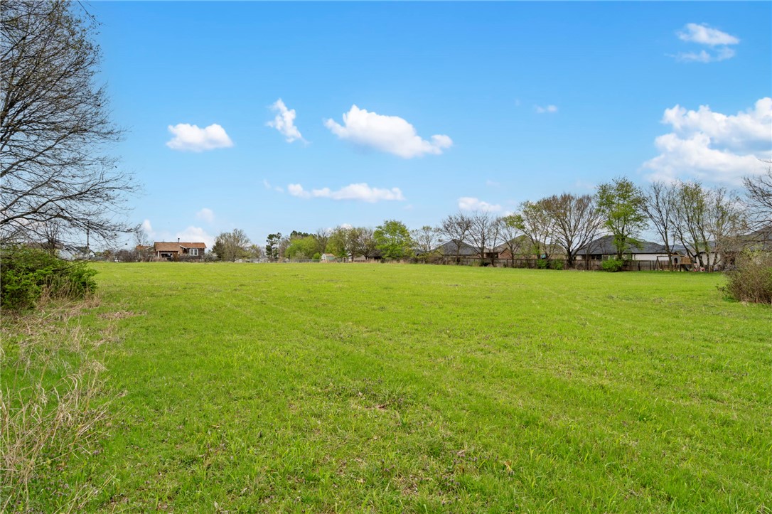 3.3 Acres m/l of open and level land waiting for the creative touch. Minutes from schools and downtown amenities. Well maintained paved road frontage. Electric, water and natural gas utilities at the street. Lot has a passing soil morphology (Perk Test). Additional adjacent acreage available if buyers prefer. Lot lines shown in pictures are estimations. Property split is pending final government approval. Also see MLS# 1338591 & 1338599