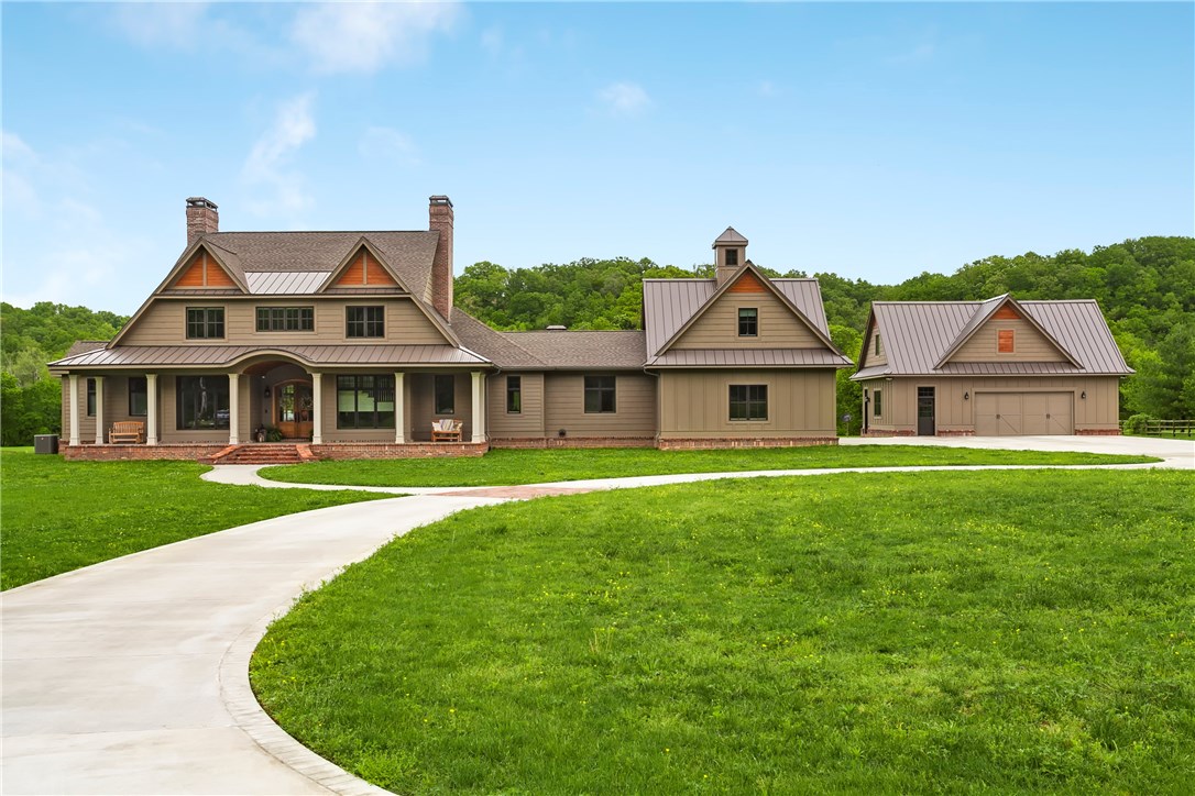 Your dream home is already finished! This custom Southern Living style estate sits on 5 private acres with incredible creek frontage, yet 5 minutes from downtown Bentonville. You’ll fall in love with the open living area with detailed ceilings & beams & beautiful oak wood floors throughout. This space is made for entertaining with 3 dishwashers, 3 ovens, 3 fireplaces, 4 master bedrooms, plus a bunk room; office space, two bonus rooms over both heated/cooled garages, & more! You won't find anything better!