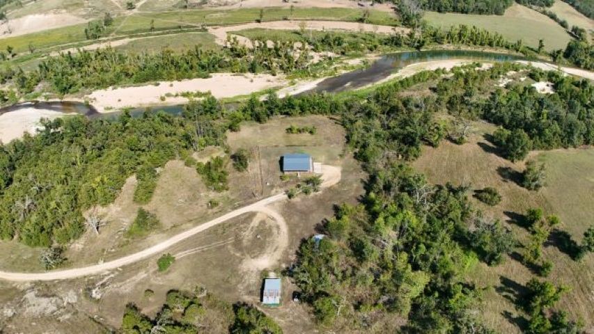 100+ Acre Recreational Farm with Home on Crooked Creek — Outdoor Paradise!  Welcome to your private retreat nestled on 100+ acres of stunning, multi-use land bordered on two sides by the pristine Crooked Creek. Whether you’re looking for a recreational haven, a working farm, or a peaceful place to call home, this property has it all. Enjoy floating, fishing, and hunting right outside your door in a true sportsman’s paradise. The land features two ponds, gently rolling pasture, and wooded areas teeming with wildlife. A barn, cow waterer, hayfield and two additional wells make this property ideal for cattle, horses, or hobby farming or could open up opportunities to build a new home or hook up an
 RV/mobile home. The cozy 2BR/2BA home offers comfort and charm with a large deck overlooking the creek—the perfect place to sip your morning coffee while taking in the sounds of nature. The unfinished basement provides room to expand or customize to your needs. Call for showing today!
