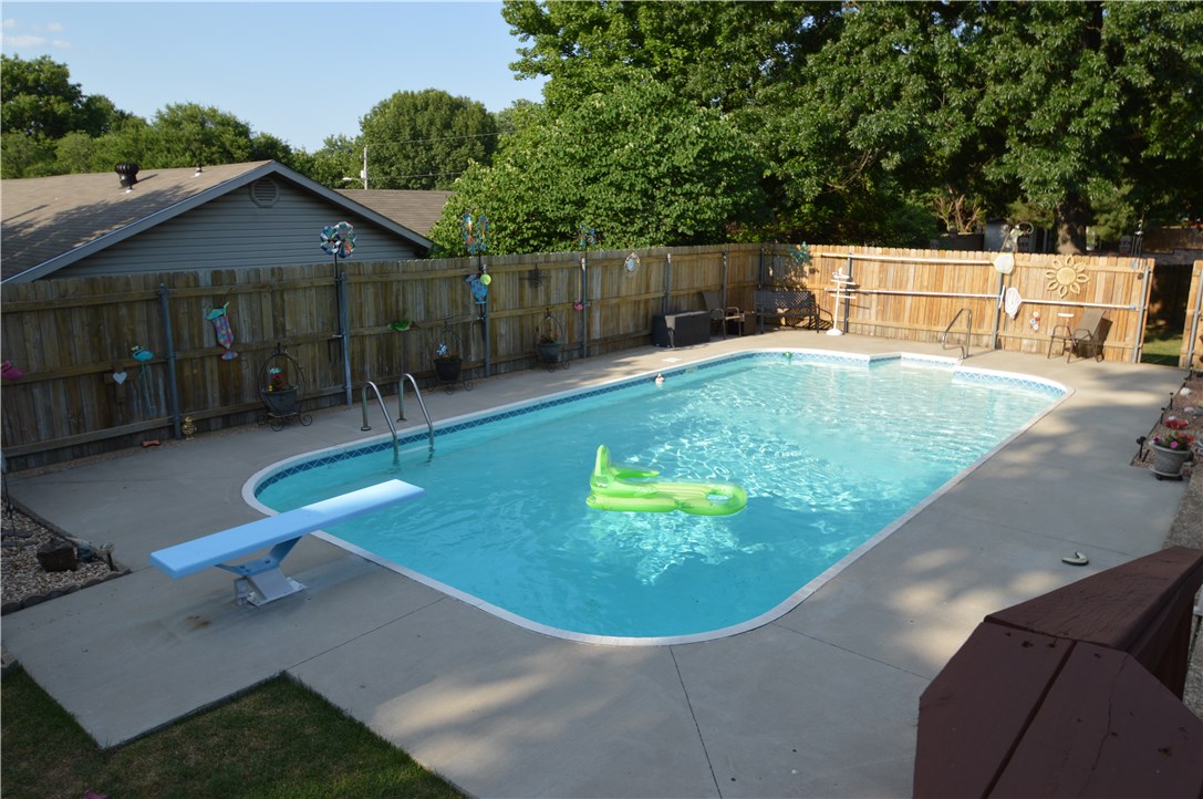 Back on the market due to buyers financing. Come and relax in your new gunite pool this summer! This 3 bed 2.5 bath 2,298 sq. ft. home is centrally located and nestled on a corner lot.  Inside you will find beautiful hardwood floors, two living areas, a formal dining room, new granite kitchen countertops, sink, and stove top.  There are newer Pella windows throughout and french doors. Roof was replaced in 2012.  Backyard is fully fenced and has two decks to enjoy the view of the pool.  Storage shed conveys.