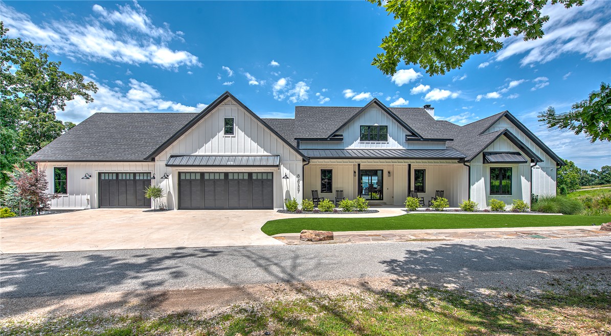 Experience lakefront living in this 2024 custom Beaver Lake retreat, with one slip in a 4-slip dock & breathtaking panoramic views. Walls of glass frame the water, while a dramatic wood-burning fireplace anchors the open-concept living space.The luxury kitchen features premium finishes, designer appliances, and a walk-in pantry with direct garage access. A stunning 1,327 sq ft covered deck offers remote screens, heat lamps, an outdoor grill, and a second wood-burning fireplace—your private outdoor living room overlooking the lake. The main level includes a private primary suite, three additional bedrooms, two full baths, laundry, and a half bath. The walk-out lower level delivers a resort-style experience with a golf simulator, gym, wine cellar, safe room, and private ADU with two bedrooms, full kitchen, and bath—ideal for guests or income potential.Complete with a private pickleball court, hot tub, fire pit, oversized epoxy-floored garage, workshop, and storage, this rare offering defines luxury lakefront living.