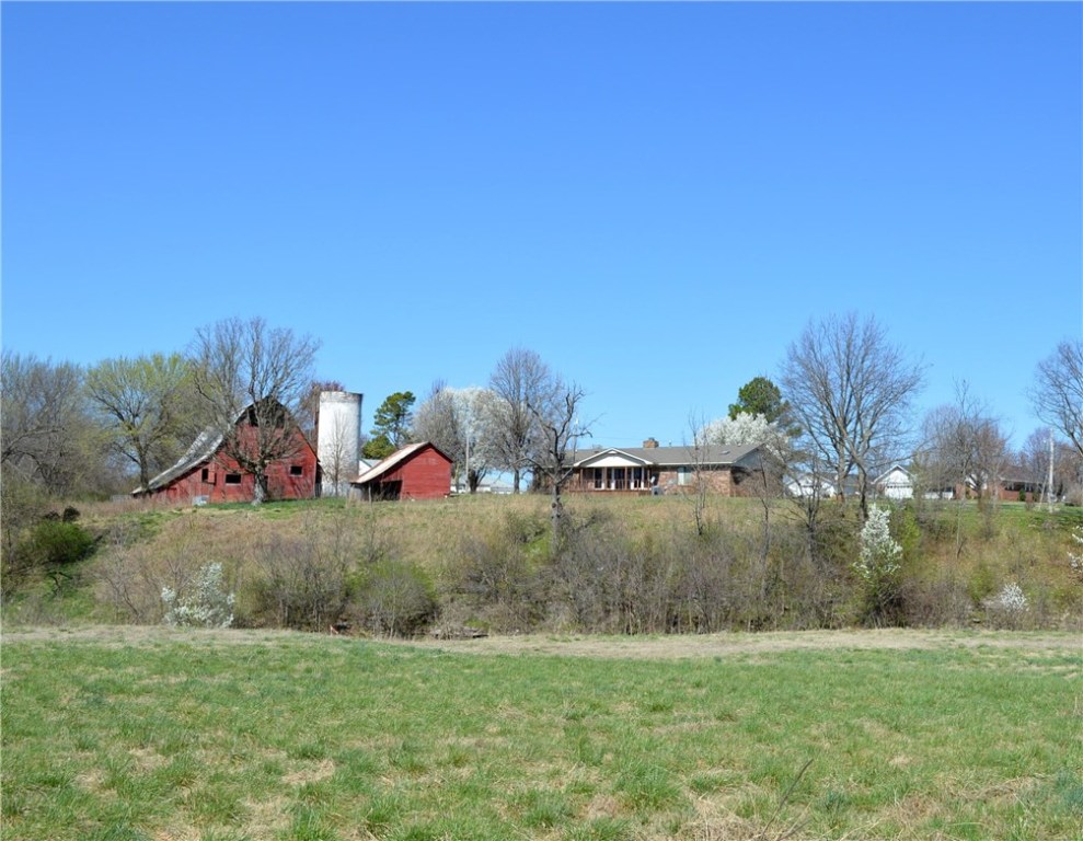 Priced well below appraisal, 3 homes w/magnificent view! A LOT of bang for your buck! Borders Goose Creek, 5.75 AC, main home custom built ‘84 3 BR/2 BA, huge vaulted living room w/stone fireplace vented to heat entire 1960 SF. Huge dining/family overlooks gorgeous valley to south. New HVAC, HWH 2009, newer roof, Anderson windows, 4x6 exterior walls. 2 additional homes on site, rent out or have family onsite. 2 barns, outbuilding, silo. Have horses, animals. Gray house needs work. AS IS.