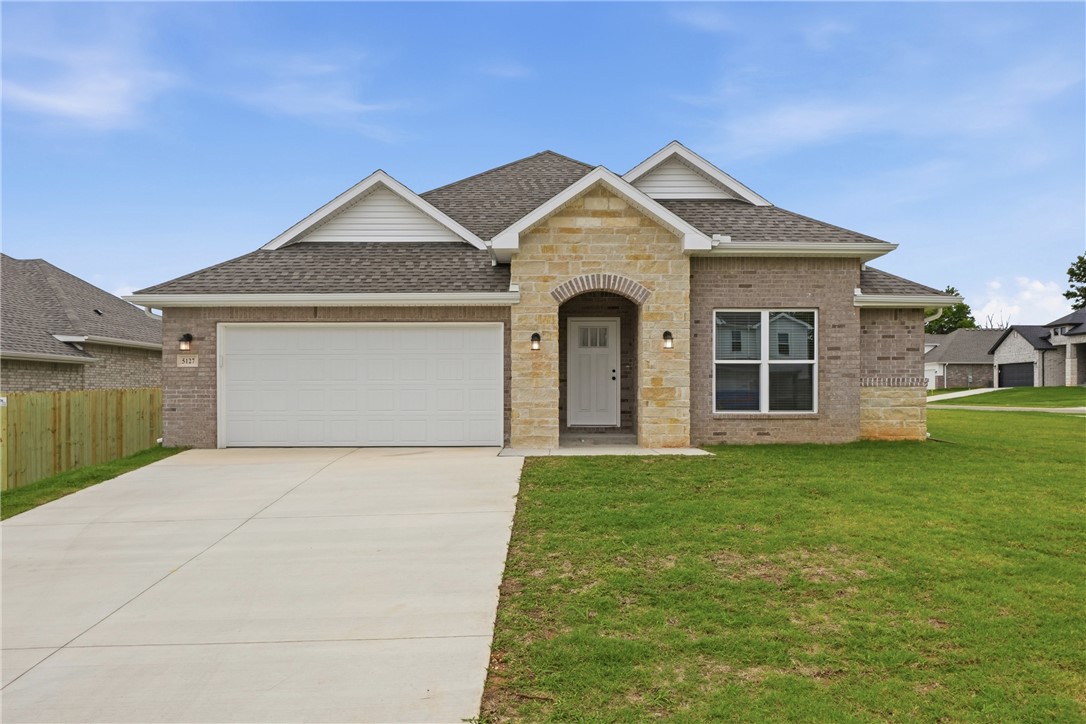 FOR LEASE. This BRAND NEW 3 bed 2 bath home offers a spacious open concept living room and kitchen with tons of natural light. The home features a split floor plan with two bedrooms at the front of the home and the master bedroom with his and her walk-in closets at the back of the house. The home is on a corner lot with a huge fully fenced-in backyard (added after photos were taken), providing additional privacy and outdoor enjoyment for tenants. 2 car garage. Small dogs allowed. Fridge included. Washer/dryer hookups on-site. Available now. This home is conveniently located down the street from the Walmart Supercenter and I-49 on-ramp, making it convenient to get anywhere in Northwest Arkansas.