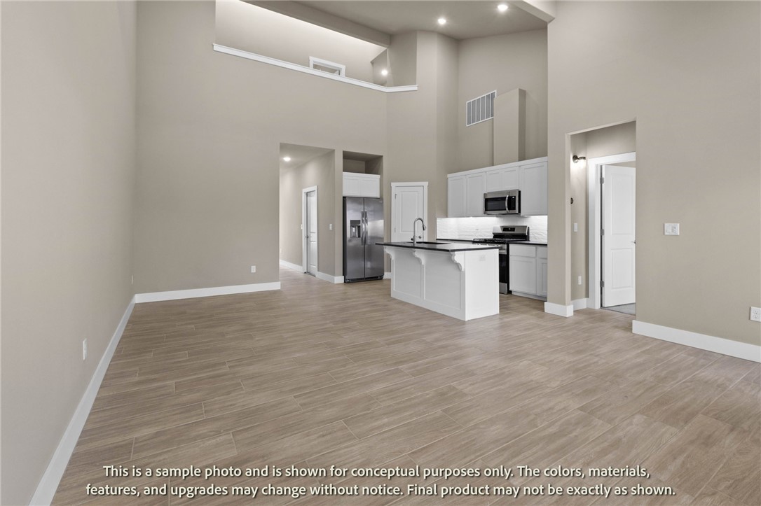 Welcome to Crystal Cove, where modern design meets everyday comfort in this beautifully crafted 3-bedroom, 2.5-bath townhome. This ~1,582 sqft layout features a desirable primary suite on the main level, offering both convenience and privacy. The open-concept living space is highlighted by a soaring vaulted ceiling and large Clerestory Windows bringing in natural light for a bright, airy feel throughout. Also featuring a sleek electric fireplace, creating an inviting atmosphere. The kitchen flows seamlessly into the dining and living areas, perfect for entertaining. Upstairs includes two additional bedrooms, a full bath, and a loft-style hallway overlooking the main living area. Enjoy outdoor living with a covered back patio and private backyard. Low-maintenance living with thoughtful design throughout makes this home ideal for a variety of lifestyles.  Builder’s credit of $3,000 and Lenders Credit Up To $5,000 with Preferred Lender.