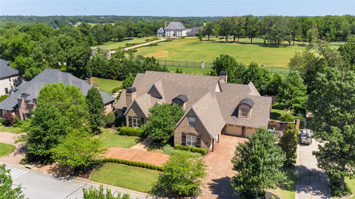 Spectacular 5 bedroom home in prestigious Pinnacle Country Club!! This designer appointed home invites you into the open & spacious floor plan boasting gorgeous hardwood floors, detailed millwork, designer lighting & updates throughout! The beautiful kitchen overlooks the breakfast room & spacious great room, featuring vaulted ceiling & hand laid stone fireplace. Dazzling updated kitchen boasts custom cabinetry, high end appliances & spacious island w/quartzite countertops. The oversized primary suite offers plenty of space to unwind w/fireside sitting area & spa-like bath.  A guest suite w/private terrace, 2nd living area, handsome study & dining rm complete the main level. Upstairs features a fully equipped home theater, 3 additional bedrooms and 2 full bathrooms.  Relax in your own private backyard oasis featuring a wrap-around covered veranda & elaborate poolside cabana w/outdoor fireplace, grilling area with bar seating & full bathroom.  The gunite pool displays a glorious sun shelf & built in basketball goal.