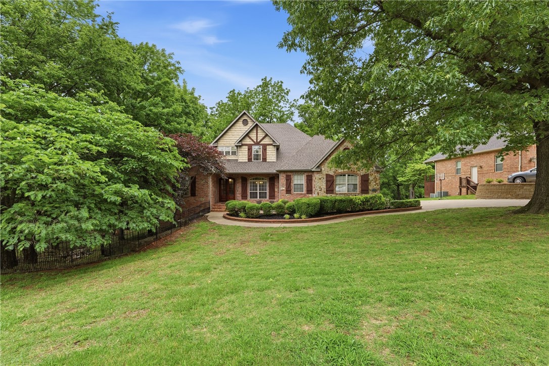 Welcome to your private, all-brick estate retreat—perfectly balancing acreage living with quick access to I-49. Sitting on 1.97 beautifully cleared acres, this stunning home is designed for entertaining. The main level showcases a spacious primary ensuite, a dedicated office, formal dining, two distinct living areas, and a large three-car garage. Eat in Kitchen features double ovens, gas range, stainless appliances & prep island.  Upstairs, you will find three additional bedrooms with walk-in closets, an adjoining bath, & a large bonus room, with wet bar, perfect for movie nights or a play space. For even more flexibility, the fully heated and cooled basement offers endless possibilities as a workshop, home gym, or extra living quarters. Step outside to the extended back deck to enjoy gorgeous views of your own private pond. Complete with recent updates including fresh flooring, modern quartz countertops, painted bathroom cabinetry, and a newly cleared backyard, this incredible property is completely move-in ready.